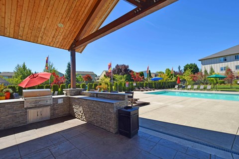 A pool area with a bar and umbrellas.