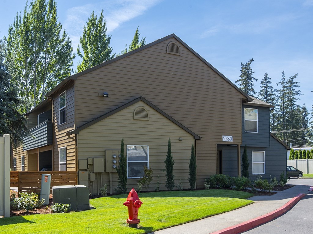 a house with a red fire hydrant in front of it