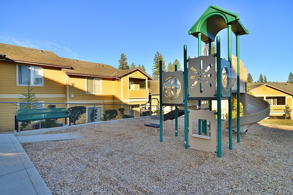 a playground with a slide and a clock