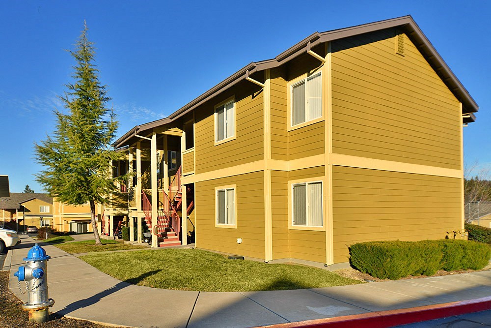 a yellow building with a blue fire hydrant in front of it