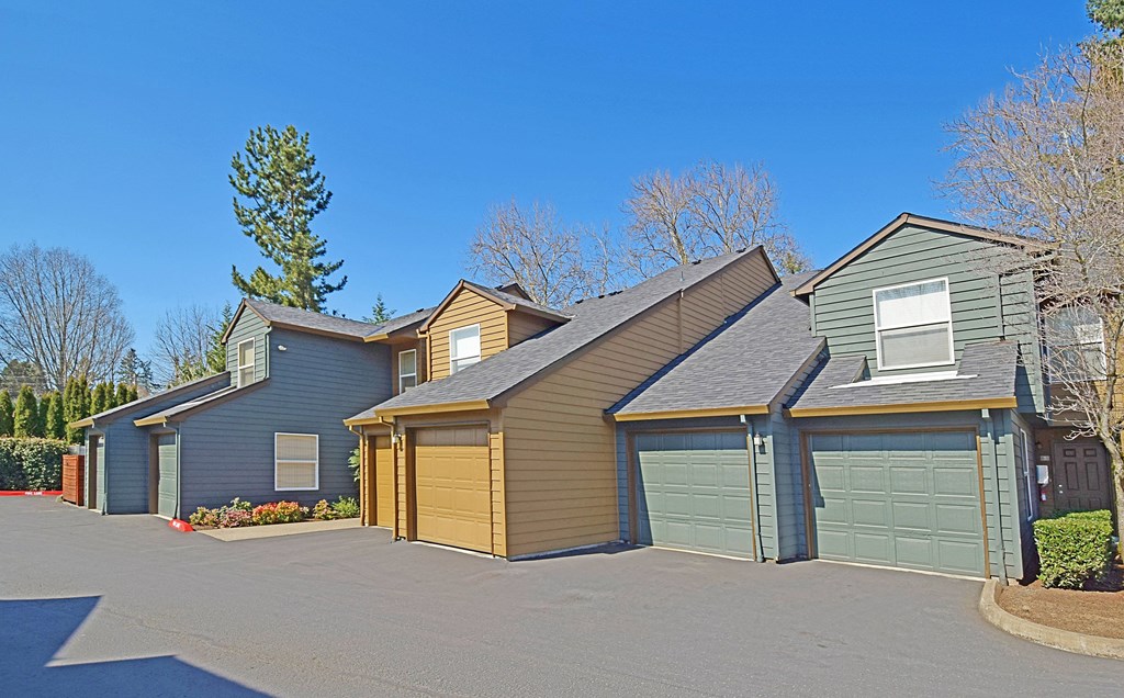 a house with two garages and two cars garage doors