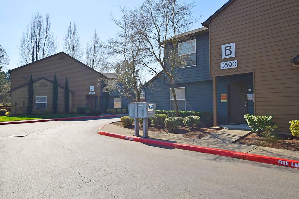 a street in front of a building with a parking meter