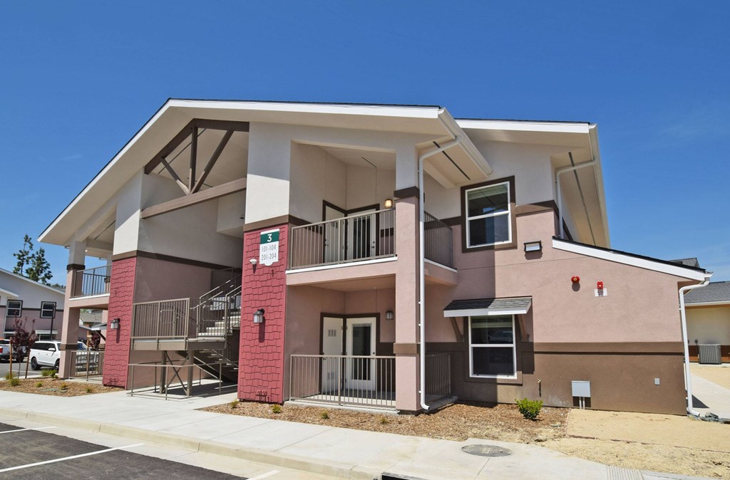 A modern two-story building with a red brick pillar.