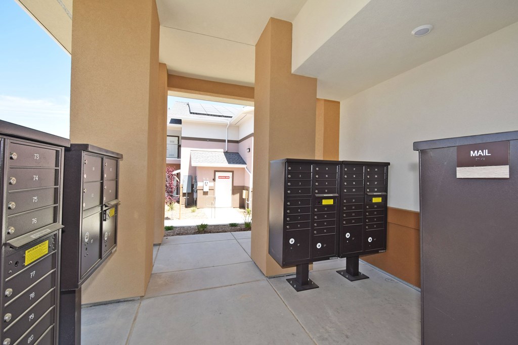 A row of mailboxes are lined up on the sidewalk.