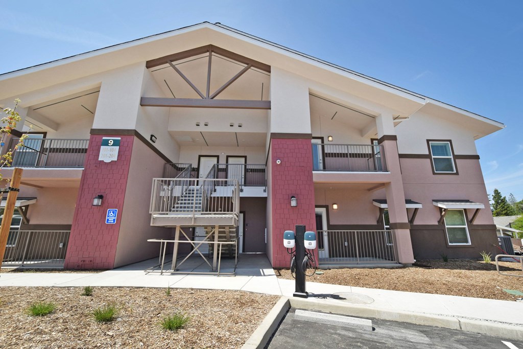 A building with a red and white exterior and a parking meter in front.
