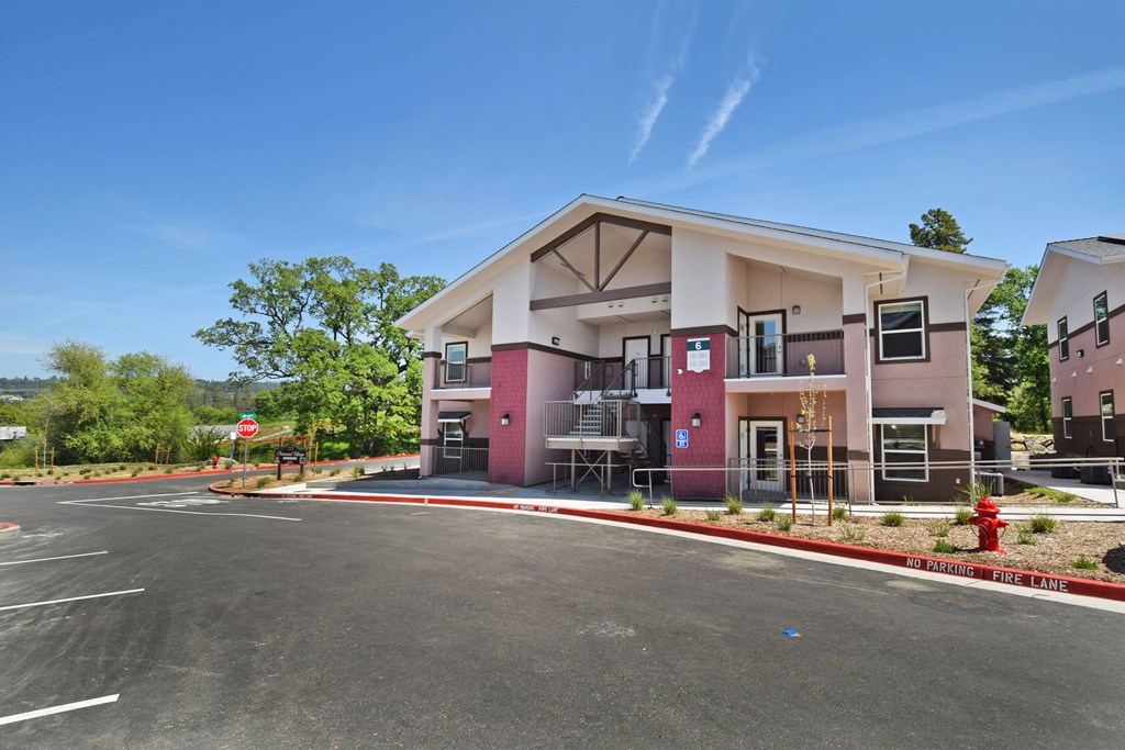 A building with a red fire hydrant in front of it.