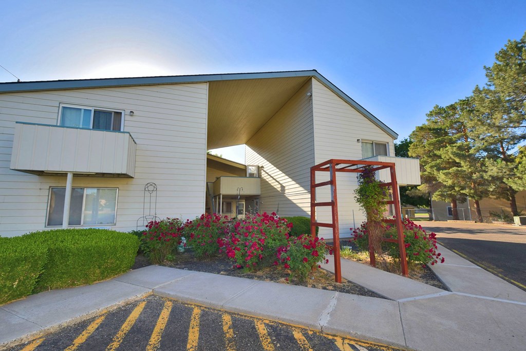 A sunny day at a residential building with a red staircase.