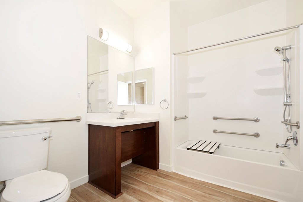 A white toilet sits next to a sink in a bathroom.