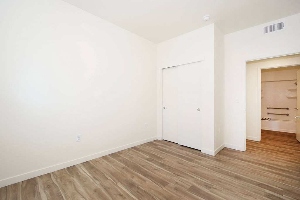 A room with wooden floors and white walls.