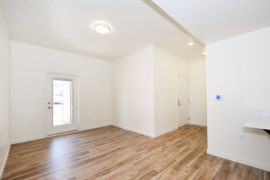 A room with wooden floors and white walls.