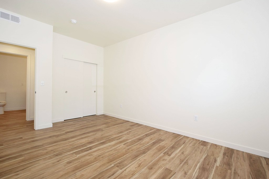 A room with a wooden floor and white walls.