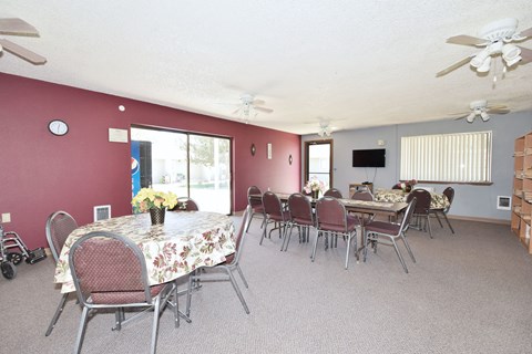 A dining room with a table set for six people.