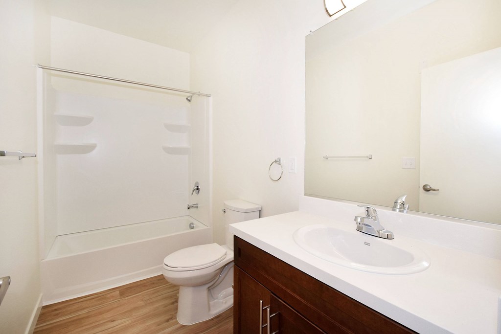 A white toilet sits next to a sink in a bathroom.