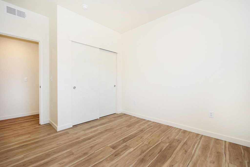 A room with a white door and a white wall.