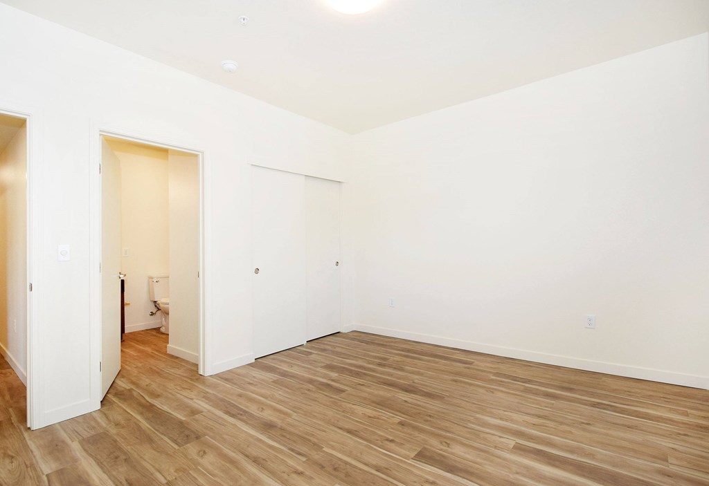 A room with wooden floors and white walls.