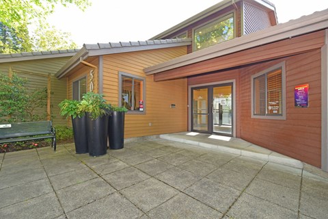 A house with a brown exterior and a grey roof.