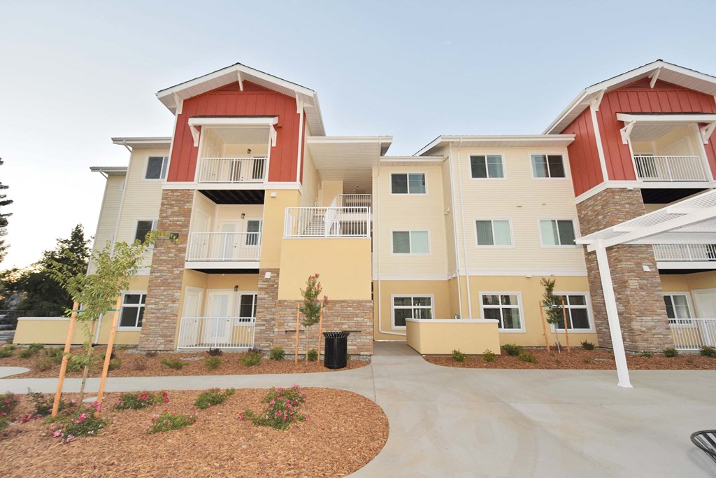 an exterior view of an apartment building with a courtyard