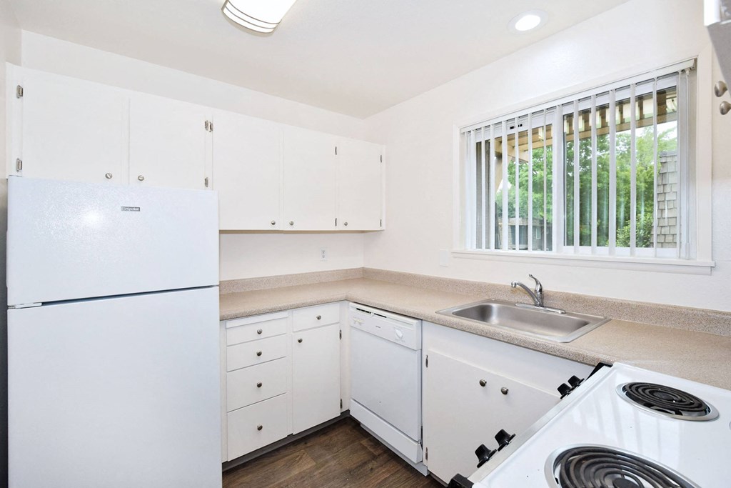 a kitchen with white appliances and white cabinets