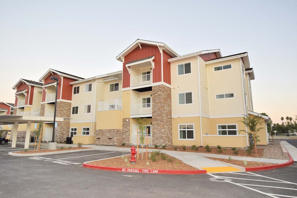a fire hydrant is in front of an apartment building