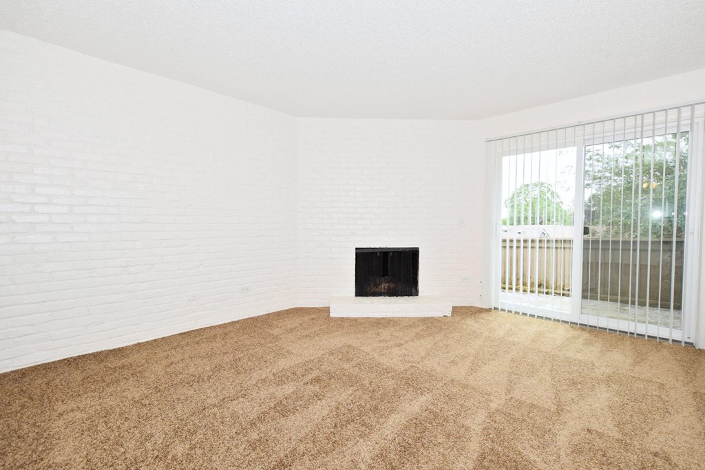 a living room with a fireplace and a window