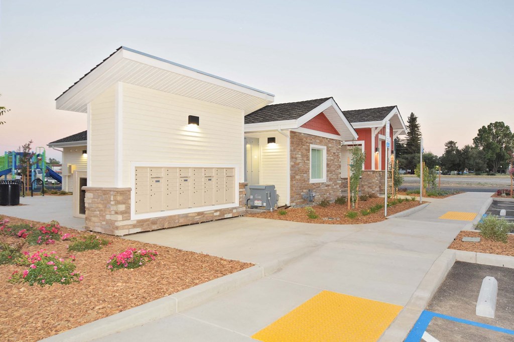 a row of houses with a sidewalk and a parking lot