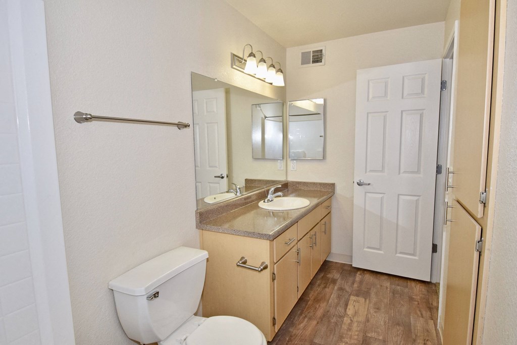 the preserve at ballantyne commons apartment bathroom with toilet sink and mirror