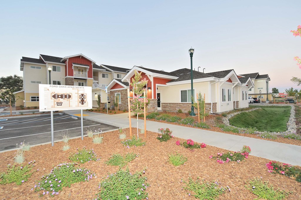 a group of houses with a sign in front of them