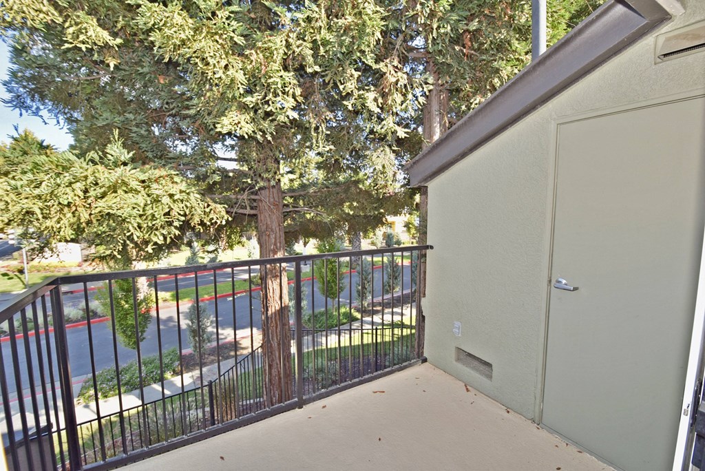 a balcony with a tree and a garage door