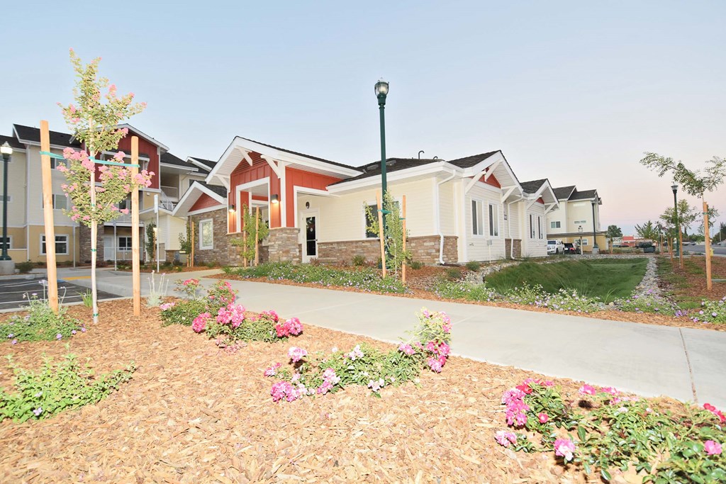 a row of houses with a sidewalk in front of them