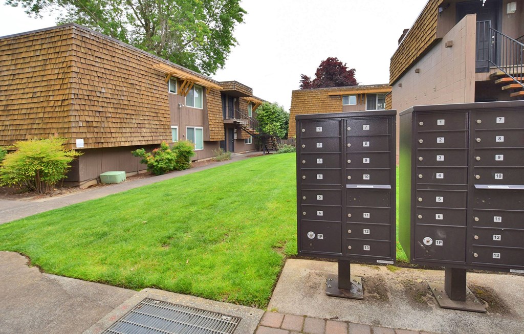 a row of mailboxes in front of a lawn
