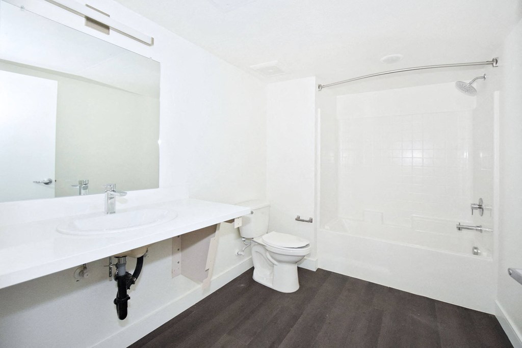 a bathroom with a toilet and a sink and a shower