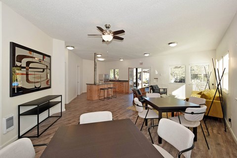 A modern dining room with a large table and chairs.