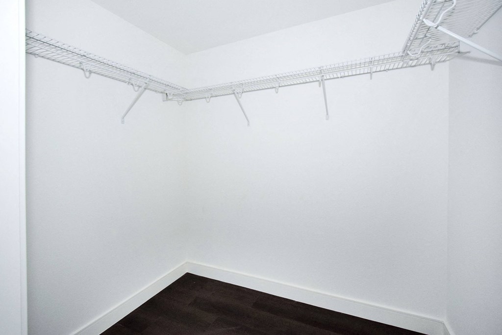 an empty room with white walls and a wood floor