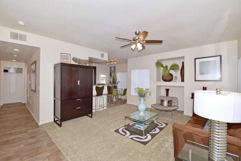 a living room with a couch and a ceiling fan