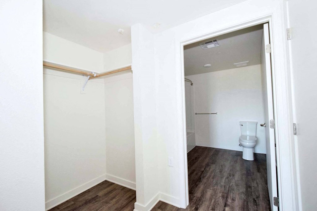 a bathroom with a toilet and a walk in closet