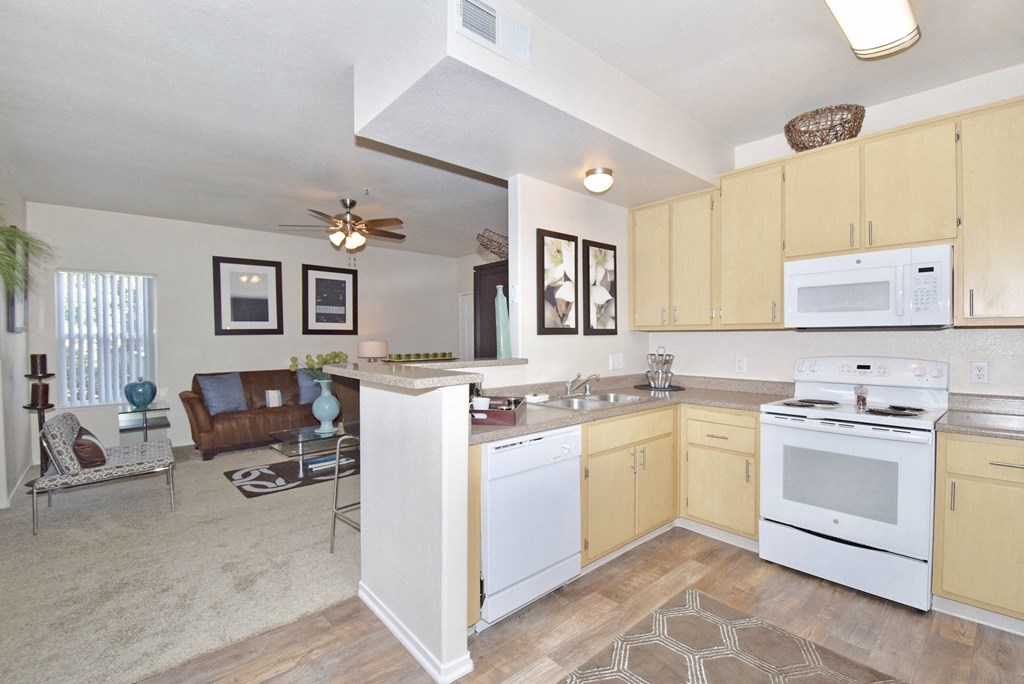 a kitchen with white appliances and a counter top