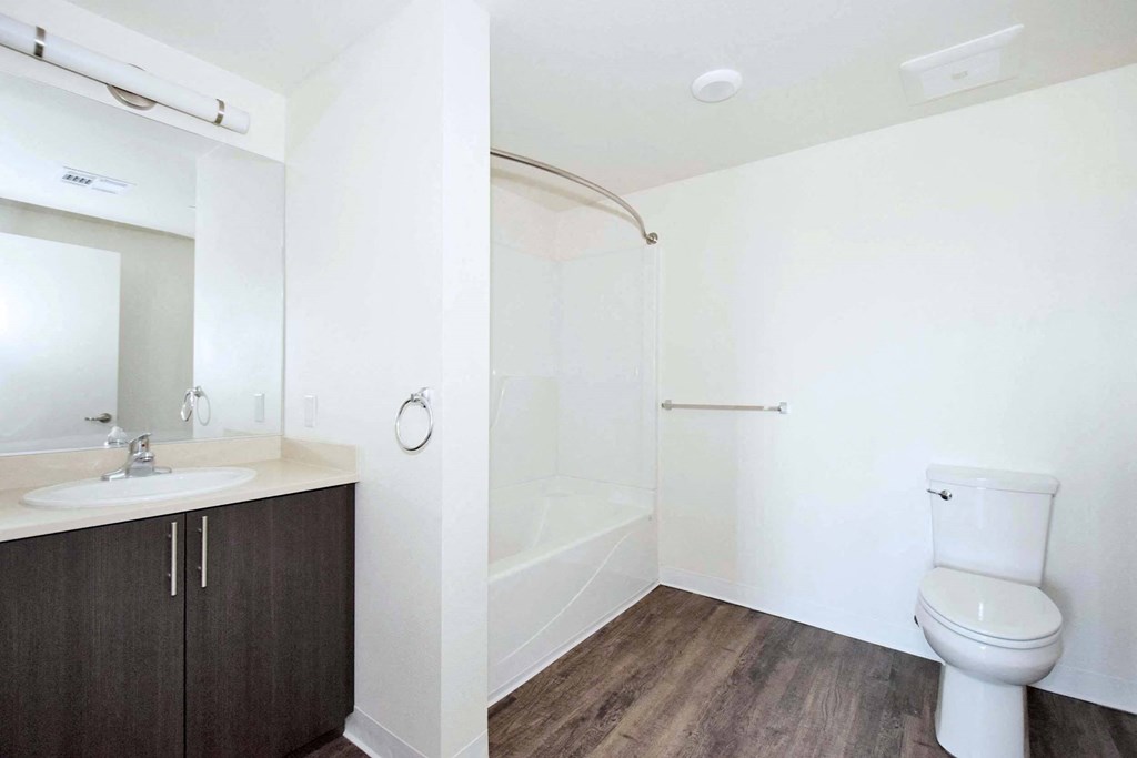 a bathroom with a toilet sink and shower