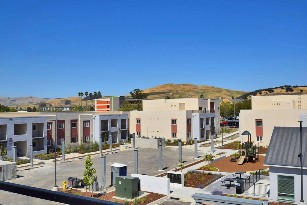 a view of a city with buildings and a mountain in the background