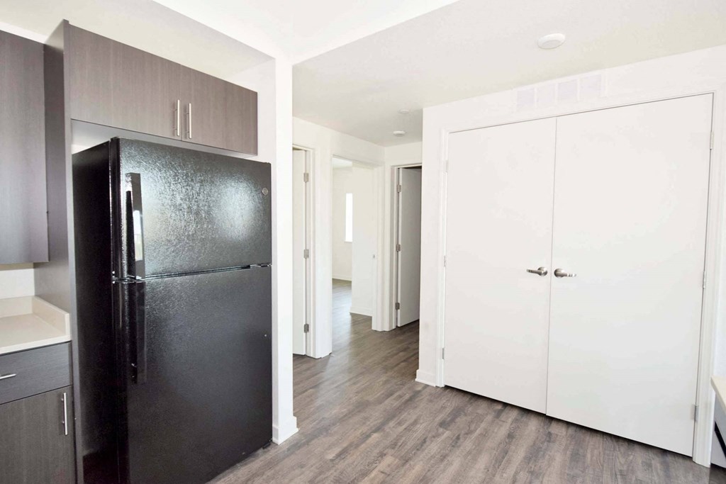 a kitchen with a refrigerator freezer next to a door