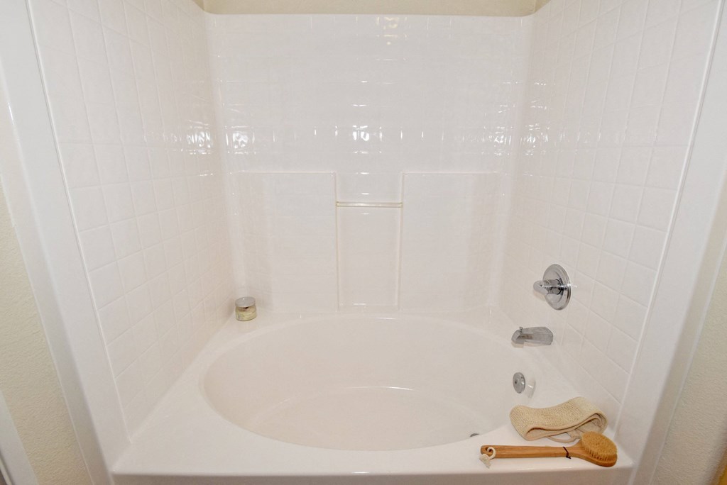 a bathroom with a white tub and a sink