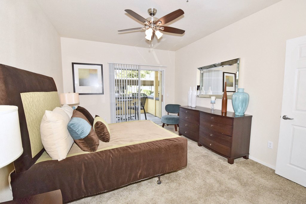 a bedroom with a bed and a ceiling fan