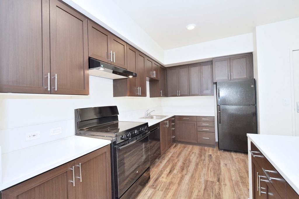 a kitchen with wooden cabinets and stainless steel appliances