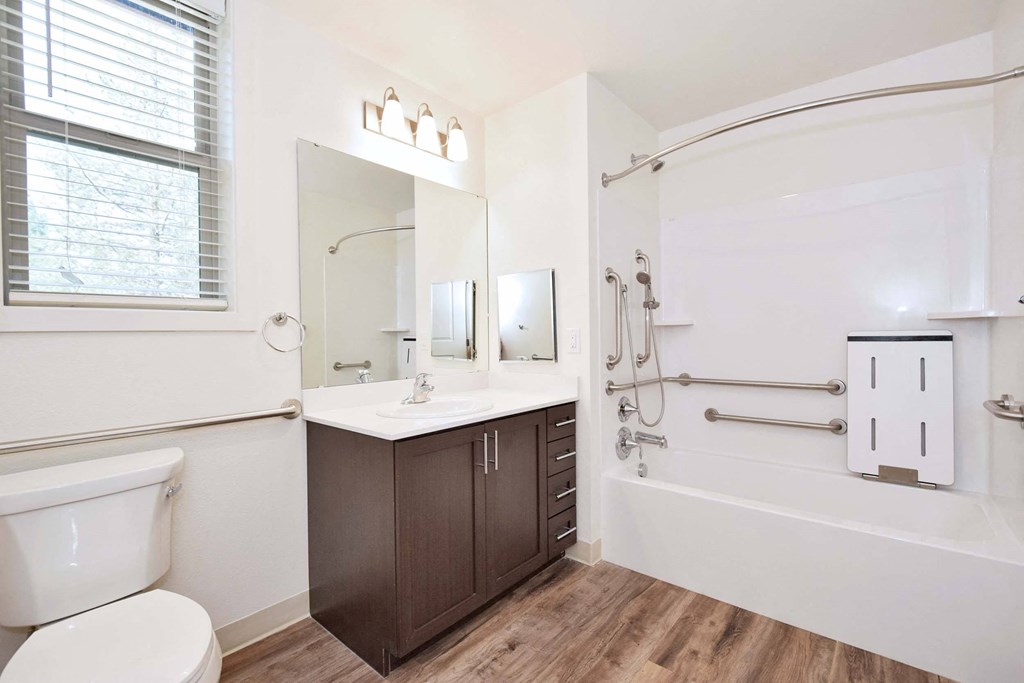 a bathroom with a shower and a toilet and a sink