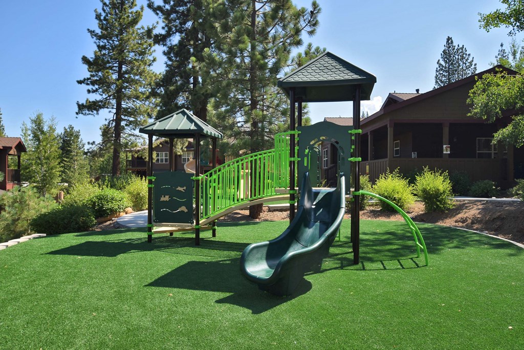 a playground with a slide and a swing set