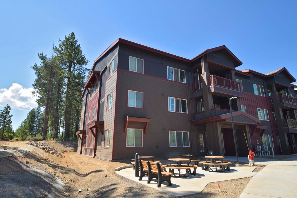 a building with picnic tables in front of it