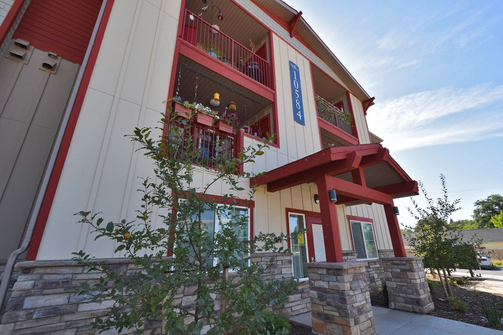 a red and white building with a blue sign on the side of it