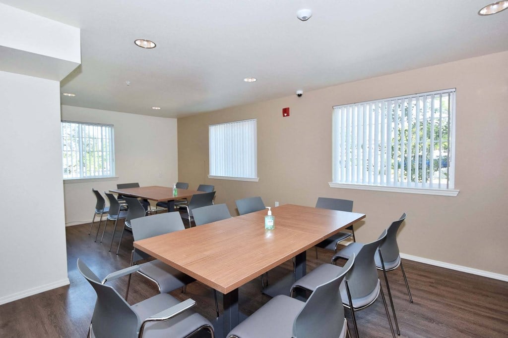 a meeting room with a large table and chairs