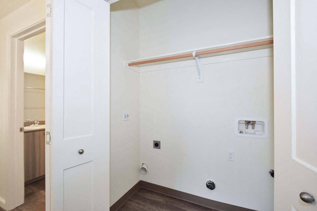 an empty room with a white wall and a closet with a sliding door