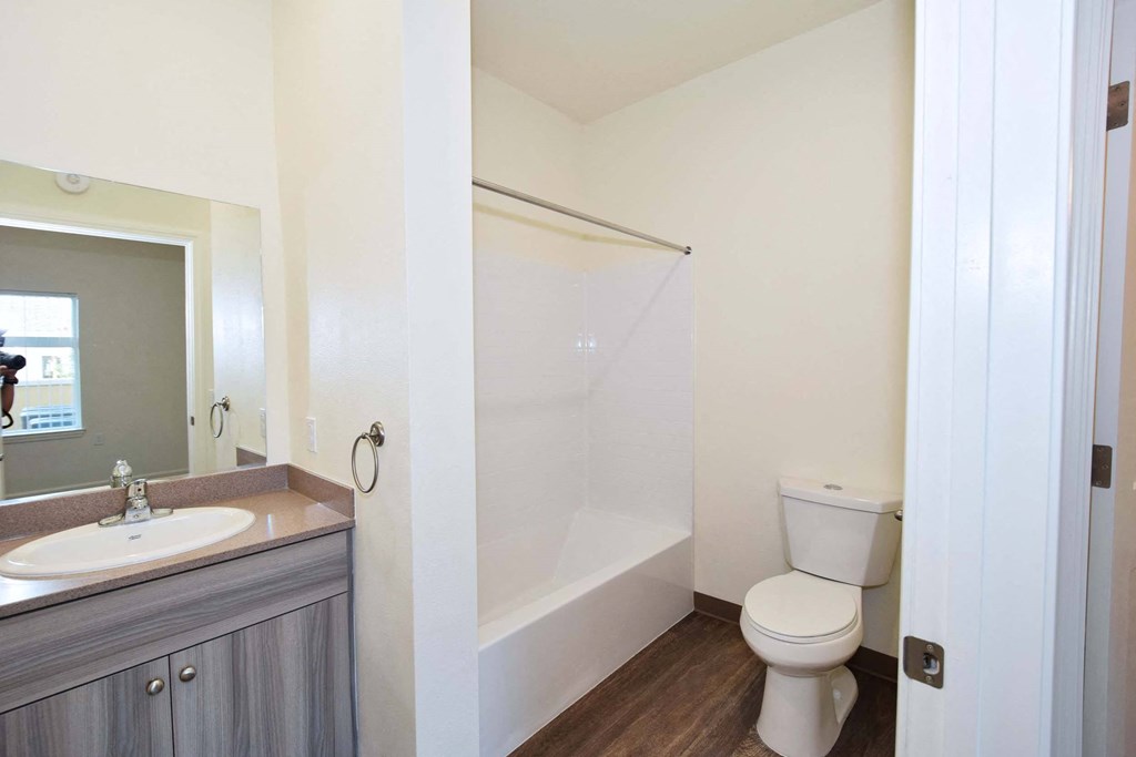 a bathroom with a toilet and a sink and a shower