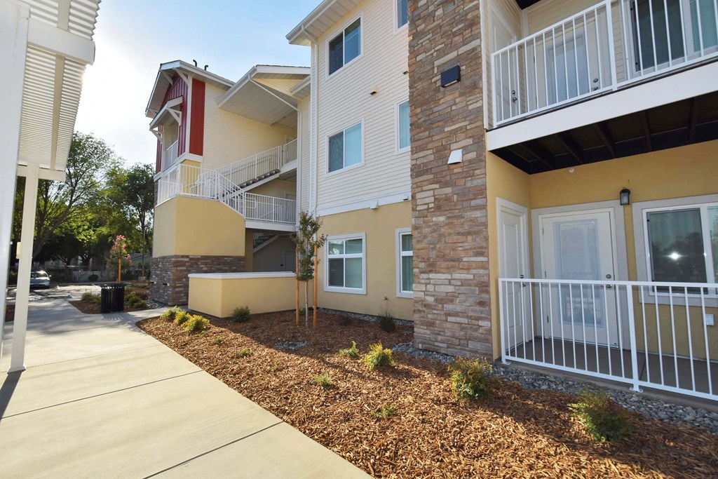 front view of an apartment building with a sidewalk